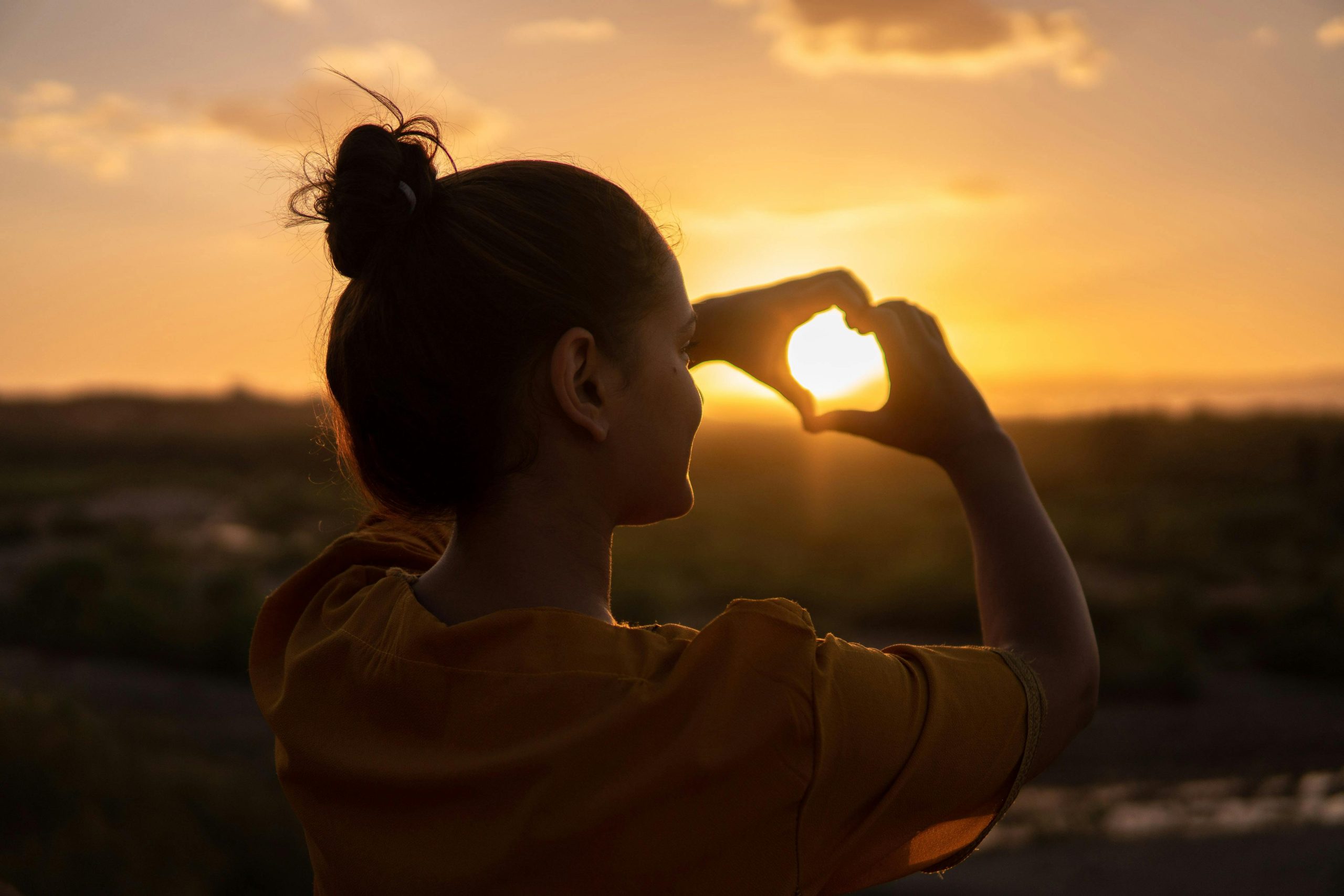 pexels-hazardos-1535244 girl creating heart shape